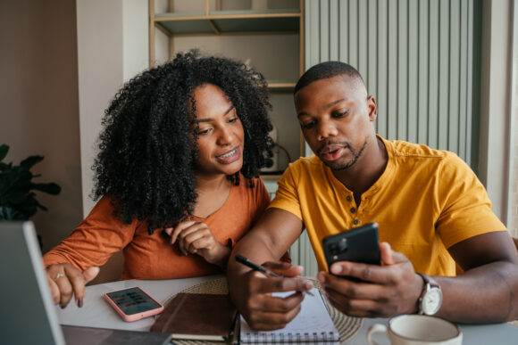 Man and woman reviewing finances on a calculator
