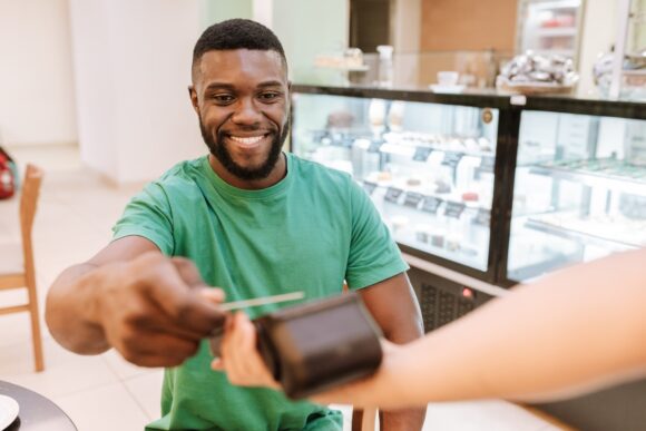 Servicemember swiping credit card at a restaurant